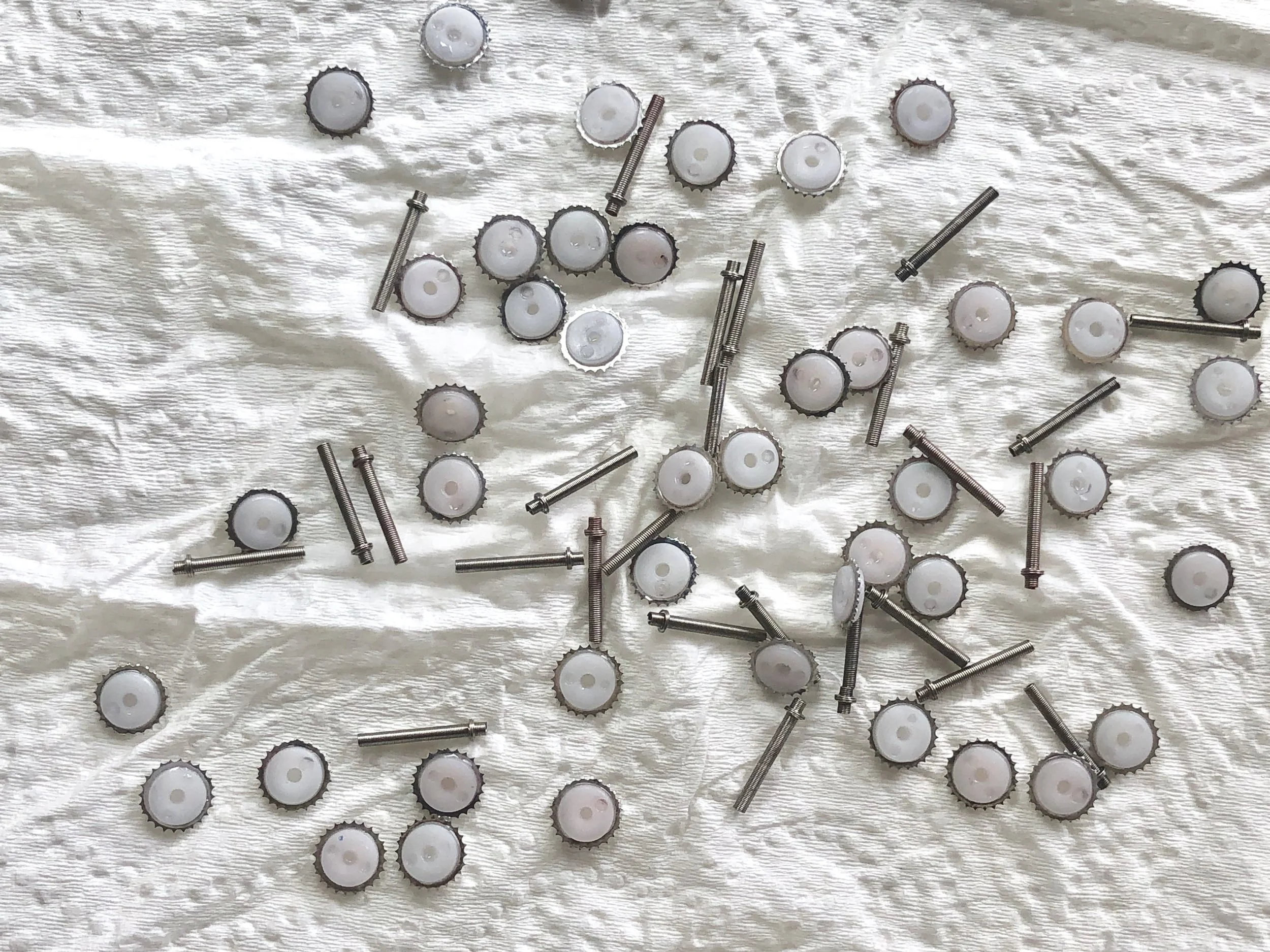 Parts after cleaning. There’s still some pink staining, but this is pretty deep discoloration, and no longer superficial residue affecting the mechanical workings of these parts.