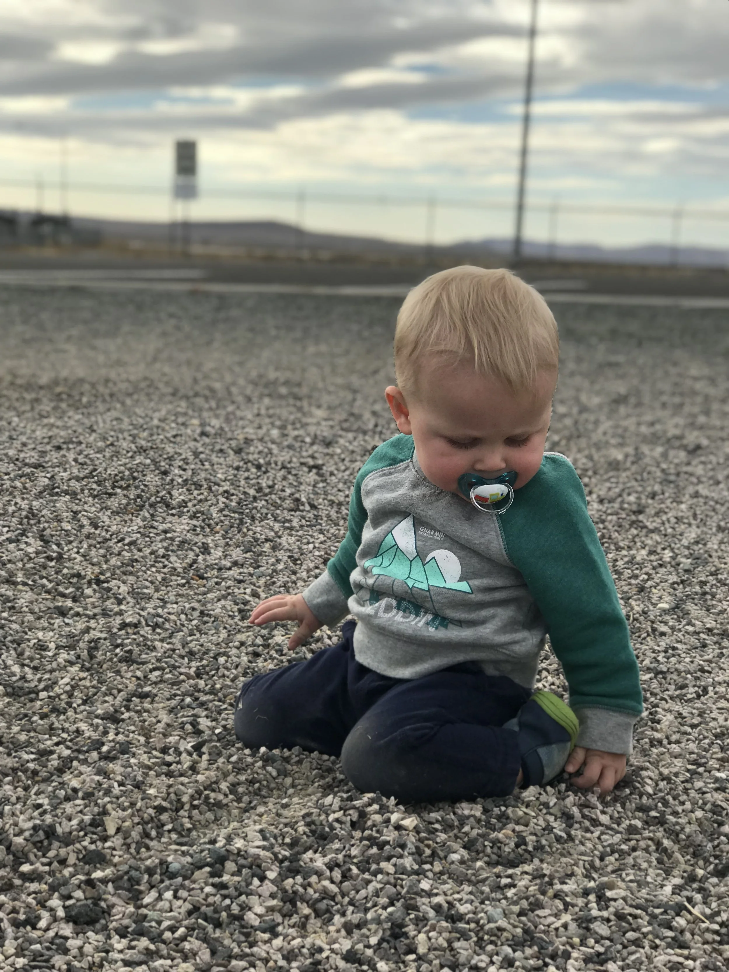 Tommy playing in the gravel at a rest stop