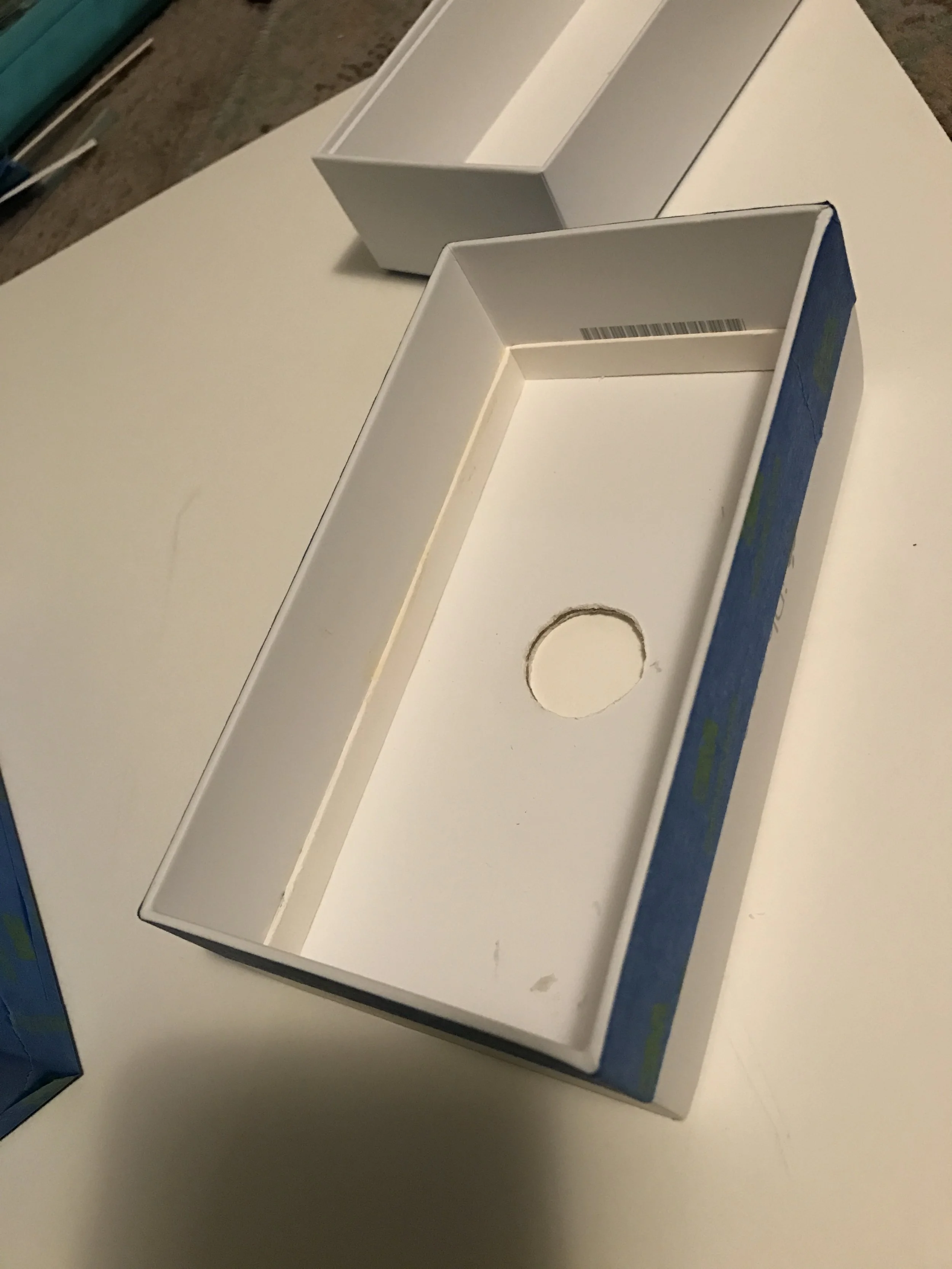  Center cut out for pinhole sheet placement, matte board glued to the inner perimeter of the box to set a 55mm 